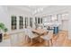 Elegant dining area leading to a gourmet kitchen, featuring hardwood floors and natural light from exterior doors at 2585 Hickory Rd, Canton, GA 30115