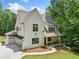 Striking two-story home with a two-car garage and covered front porch with wood columns at 2585 Hickory Rd, Canton, GA 30115