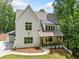 Beautiful white home features an attached two-car garage and welcoming front porch at 2585 Hickory Rd, Canton, GA 30115