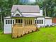 Back exterior of home with deck, backyard and wooded lot at 2585 Hickory Rd, Canton, GA 30115