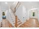 Inviting foyer with hardwood floors, staircase, and elegant lighting at 2585 Hickory Rd, Canton, GA 30115
