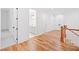 Upper hallway with hardwood floors, leading to a bathroom and closet space at 2585 Hickory Rd, Canton, GA 30115