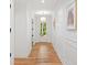 Bright hallway featuring wood floors, white trim, and natural light at 2585 Hickory Rd, Canton, GA 30115