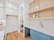 Butler's pantry area with white cabinets, marble countertops, wood accents, and under cabinet microwave at 2585 Hickory Rd, Canton, GA 30115