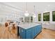 Open-concept kitchen with island, stainless appliances, and abundant natural light from the nearby french doors at 2585 Hickory Rd, Canton, GA 30115