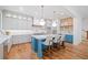 Renovated kitchen featuring an island with seating, pendant lights, stainless appliances, and hardwood flooring at 2585 Hickory Rd, Canton, GA 30115
