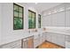 Bright and modern kitchen featuring white cabinets, a farmhouse sink, and marble countertops at 2585 Hickory Rd, Canton, GA 30115