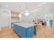 Spacious open-concept kitchen with island seating, hardwood floors, connecting to dining and living spaces at 2585 Hickory Rd, Canton, GA 30115