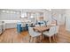 Well-lit kitchen with an island, hardwood floors, pendant lighting, and a staircase leading to the upper level at 2585 Hickory Rd, Canton, GA 30115