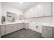 Laundry room with ample storage, a sink, and light gray tile flooring at 2585 Hickory Rd, Canton, GA 30115