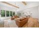 Open concept living room featuring high ceilings, hardwood floors, and a view to the dining area and chef's kitchen at 2585 Hickory Rd, Canton, GA 30115