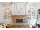 A cozy living room features a stone fireplace, custom built-ins, hardwood flooring, and a decorative modern painting at 2585 Hickory Rd, Canton, GA 30115