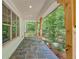 Covered porch with stone flooring, natural wood pillars, and views of the yard at 2585 Hickory Rd, Canton, GA 30115