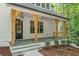 Inviting front porch with stone tile flooring and wood support beams at 2585 Hickory Rd, Canton, GA 30115
