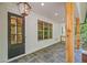 Covered front porch features stone tile flooring and natural wood columns at 2585 Hickory Rd, Canton, GA 30115