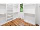 Spacious walk-in closet with custom shelving and a window for natural light at 2585 Hickory Rd, Canton, GA 30115