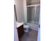 Bathroom featuring tile flooring, a standard toilet, vanity sink, and a shower/tub combo with sliding glass doors at 3655 Peachtree Rd # 203, Atlanta, GA 30319