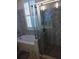 Modern bathroom featuring mosaic tile, glass shower door, and separate jacuzzi tub at 3655 Peachtree Rd # 203, Atlanta, GA 30319