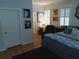 Bedroom features bright natural light, wood floors, and decorative wall art at 3655 Peachtree Rd # 203, Atlanta, GA 30319