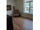Bedroom space showcasing hardwood floors, natural light from a large window, and artistic decor at 3655 Peachtree Rd # 203, Atlanta, GA 30319