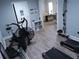 View of the fitness area with treadmills, stationary bike, weights and a shelving unit with various gear at 3655 Peachtree Rd # 203, Atlanta, GA 30319
