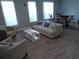 Bright living room with large windows, hardwood floors, and stylish modern furniture at 3655 Peachtree Rd # 203, Atlanta, GA 30319