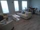 Bright living room with hardwood floors, modern furniture, sofa, and large windows with bright natural light at 3655 Peachtree Rd # 203, Atlanta, GA 30319
