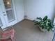 Small patio with neutral tile flooring, rocking chair, large plant, and a sliding glass door at 3655 Peachtree Rd # 203, Atlanta, GA 30319