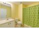 A full bath with a single sink vanity and shower with patterned curtain at 4150 Soaring Dr, Douglasville, GA 30135