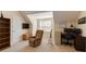 An organized bedroom with a large chair, desk, TV, and guitar at 4150 Soaring Dr, Douglasville, GA 30135