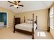 A staged bedroom with ceiling fan, wood four poster bed, dresser, and large window for lots of natural light at 4150 Soaring Dr, Douglasville, GA 30135