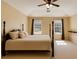 A staged bedroom with ceiling fan, wood four poster bed and large windows for lots of natural light at 4150 Soaring Dr, Douglasville, GA 30135