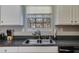 Close-up of the stainless steel sink, faucet, and countertops in a well-lit kitchen at 4150 Soaring Dr, Douglasville, GA 30135