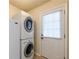 Convenient laundry room with stacked washer and dryer units and a bright, clean aesthetic at 4150 Soaring Dr, Douglasville, GA 30135