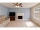 Comfortable living room featuring a fireplace and a large window with natural light at 4150 Soaring Dr, Douglasville, GA 30135