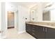 Well-lit bathroom featuring double sinks, granite counters, and a glass enclosed shower and a walk-in closet at 4561 Olde Perimeter Way # 2102, Atlanta, GA 30346