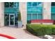Exterior shot of a building entrance framed by greenery and marked with clear signage at 4561 Olde Perimeter Way # 2102, Atlanta, GA 30346