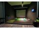 State-of-the-art golf simulator room with a putting green and modern equipment for golf enthusiasts at 4561 Olde Perimeter Way # 2102, Atlanta, GA 30346