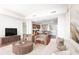 Cozy living room leads into kitchen with stone counters, a breakfast bar, and expansive views of the city skyline at 4561 Olde Perimeter Way # 2102, Atlanta, GA 30346