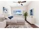 Relaxing bedroom featuring modern furnishings, bright window with city views, and ceiling fan at 4561 Olde Perimeter Way # 2102, Atlanta, GA 30346