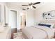 Inviting main bedroom featuring modern furnishings, bright window with city views, and ceiling fan at 4561 Olde Perimeter Way # 2102, Atlanta, GA 30346