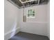 Bright basement space featuring a window, painted concrete block wall and smooth concrete floor at 130 Opal Ln, Carrollton, GA 30116