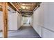 Large unfinished basement area with concrete floor, white walls, open ceiling, and utilities access at 130 Opal Ln, Carrollton, GA 30116