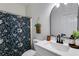 Stylish bathroom with a floral shower curtain, modern vanity, and decorative accents at 130 Opal Ln, Carrollton, GA 30116