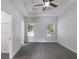 Spacious bedroom with a tray ceiling, ceiling fan and natural light from the two windows at 130 Opal Ln, Carrollton, GA 30116