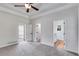 Large bedroom with tray ceilings, ceiling fan, and open doorways to other rooms, perfect for relaxing at 130 Opal Ln, Carrollton, GA 30116