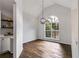 Bright dining area featuring a modern chandelier, hardwood floors, and a large window at 130 Opal Ln, Carrollton, GA 30116