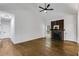 Vaulted ceiling living room boasts a cozy fireplace, gleaming hardwood floors, and ample natural light at 130 Opal Ln, Carrollton, GA 30116