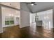 Open-concept living area showcasing hardwood floors, modern lighting fixtures, and multiple entryways at 130 Opal Ln, Carrollton, GA 30116