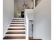 Bright staircase with hardwood steps, white risers, and a contemporary open railing design at 130 Opal Ln, Carrollton, GA 30116